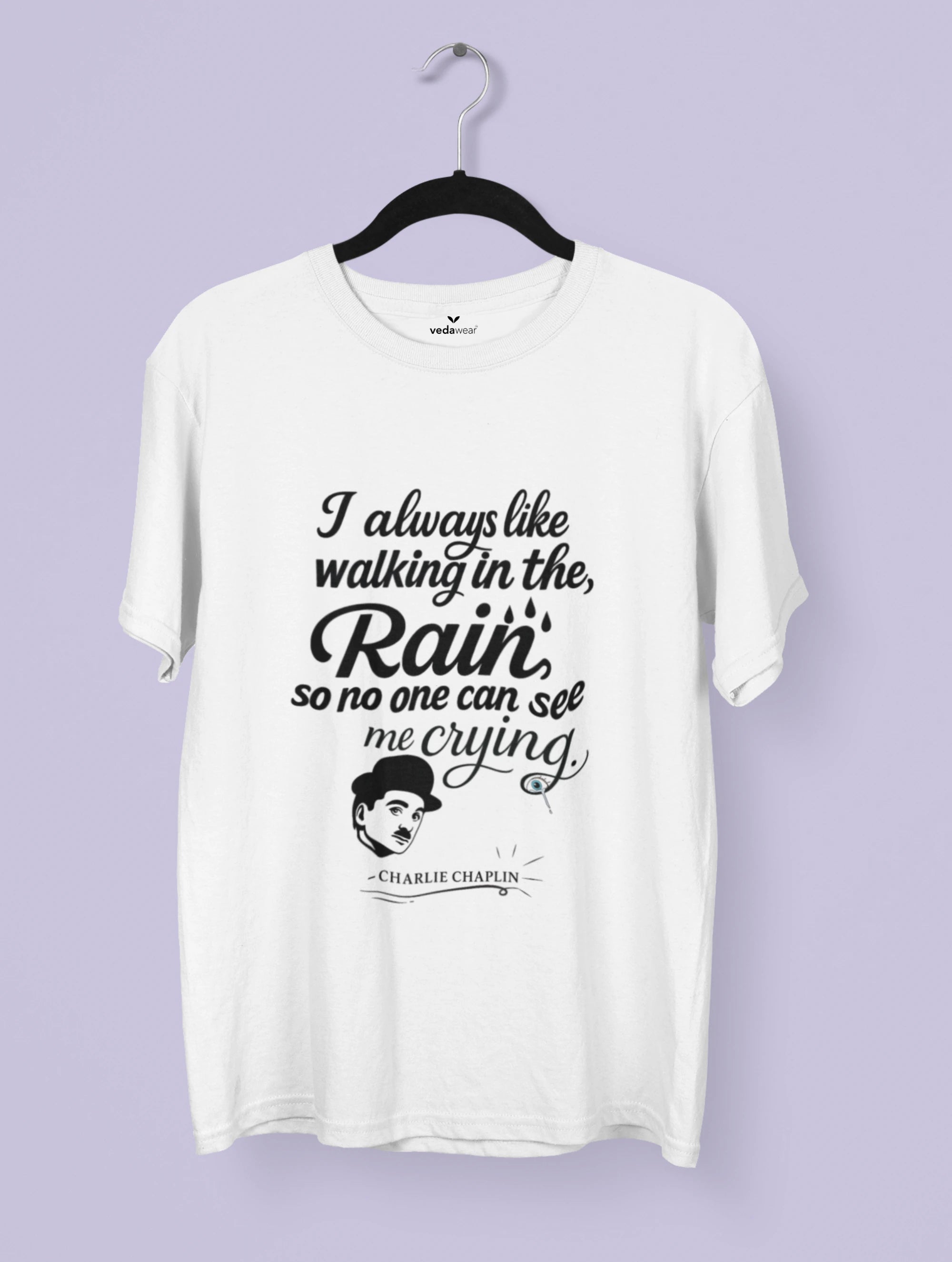 White t-shirt with black text and a graphic of Charlie Chaplin on a hanger against a light purple background