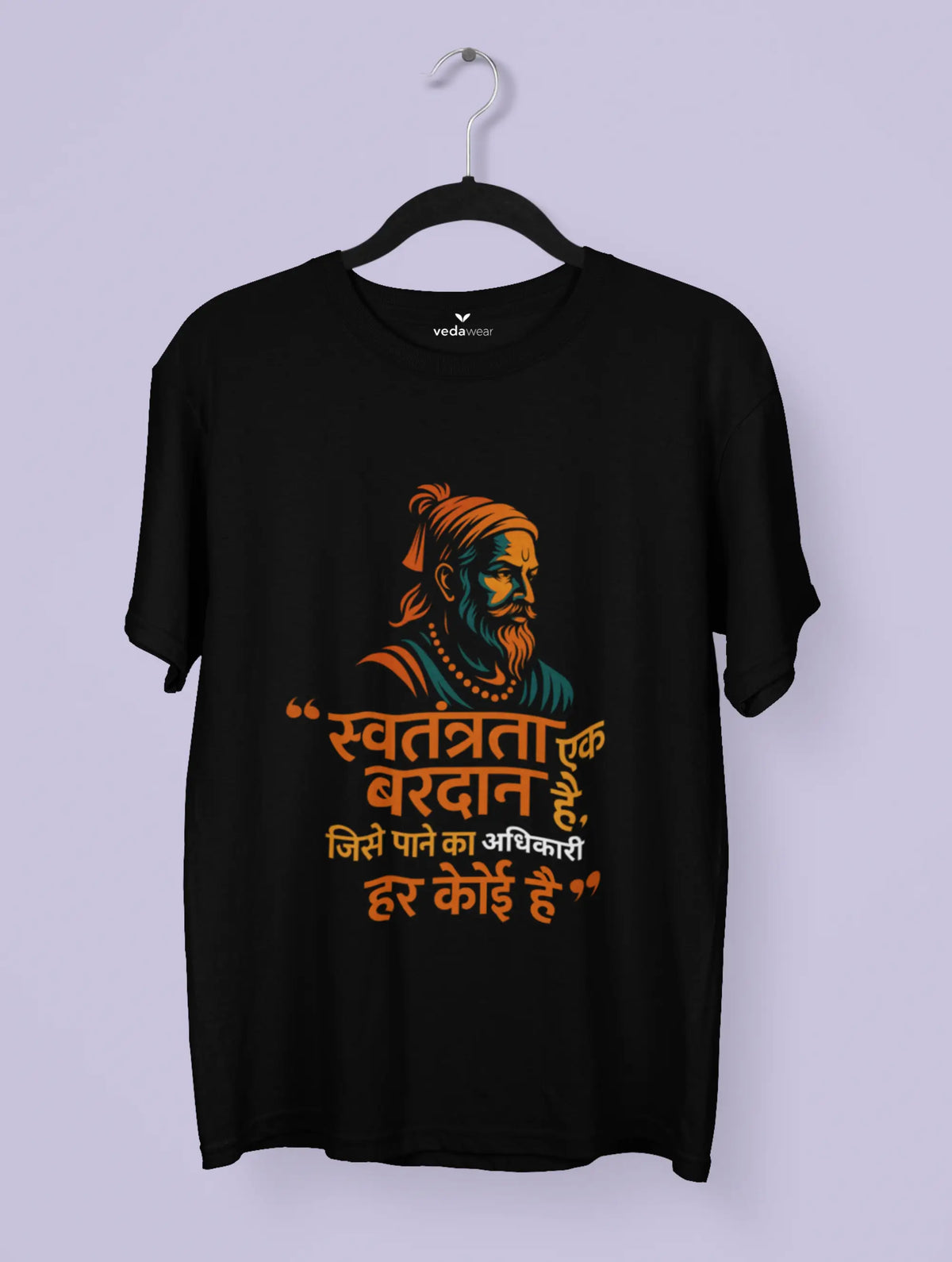 Black t-shirt with a colorful graphic and text on a hanger against a light purple background