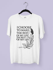 White t-shirt with motivational quote on a hanger against a light purple background