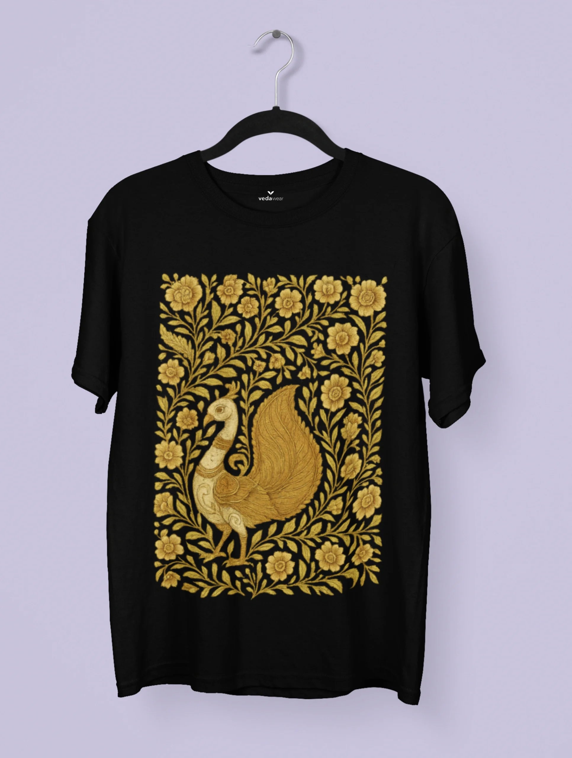 Golden Kalamkari peacock artwork on a black Vedawear premium tee, featuring intricate floral patterns and traditional Indian folk art detailing.