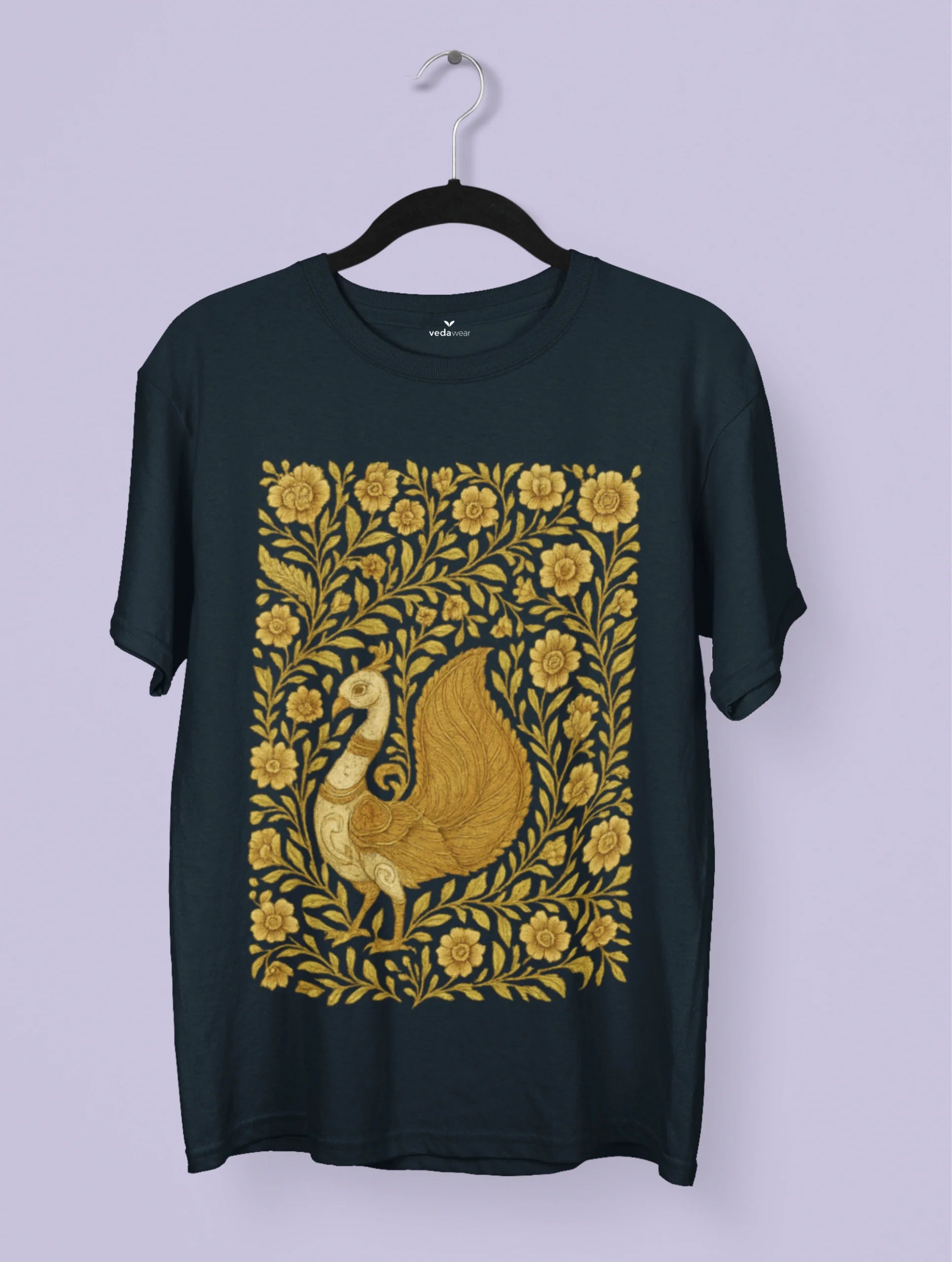 Golden Kalamkari peacock artwork on a black Vedawear premium tee, featuring intricate floral patterns and traditional Indian folk art detailing.