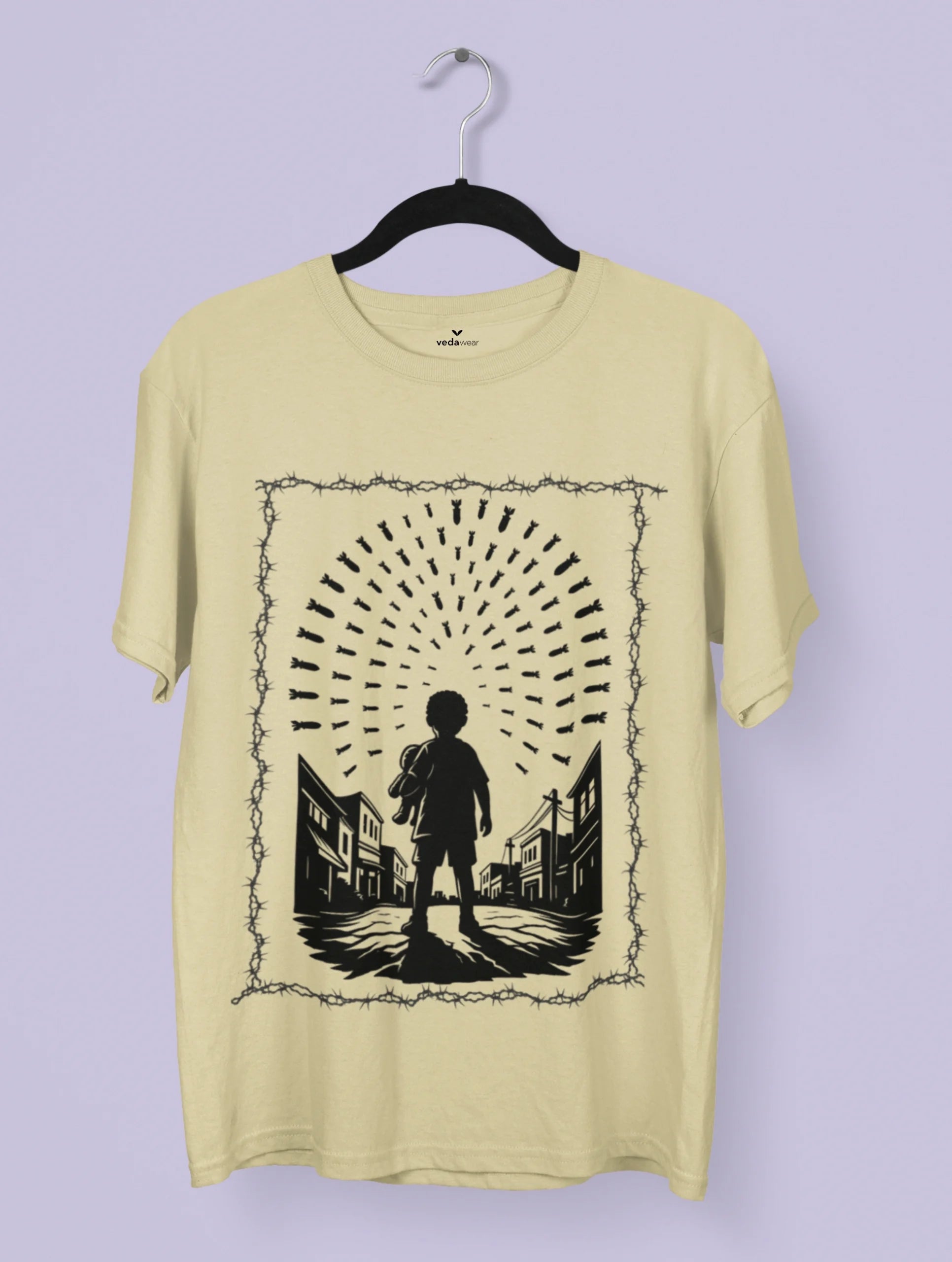 Innocence Under Fire – Anti-War Premium Tee by Vedawear, black silhouette of child under falling bombs framed in barbed wire, DTG printed on Supima cotton
