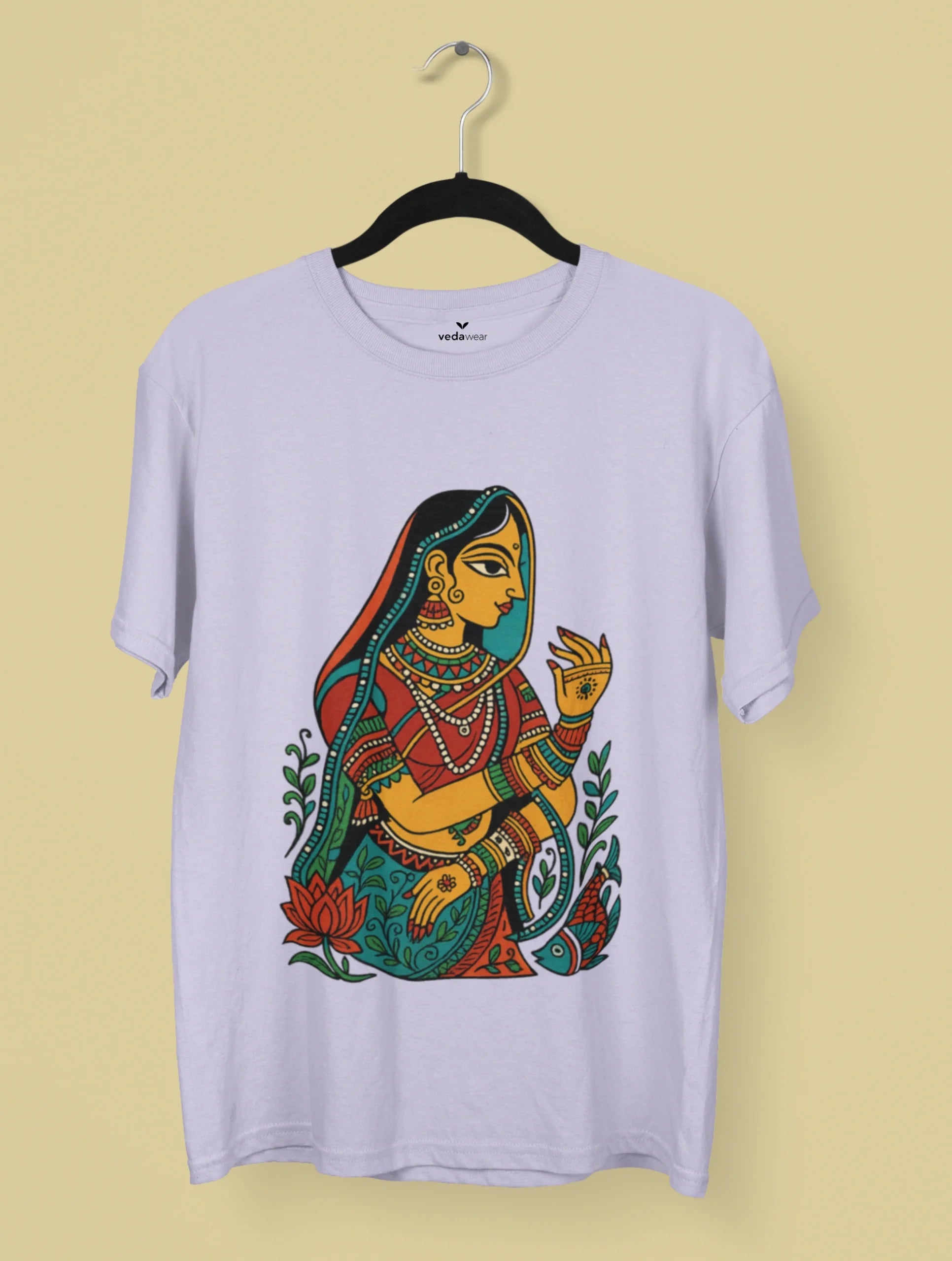 Madhubani folk art T-shirt design featuring a traditional Indian woman surrounded by lotus and fish motifs in vibrant colors